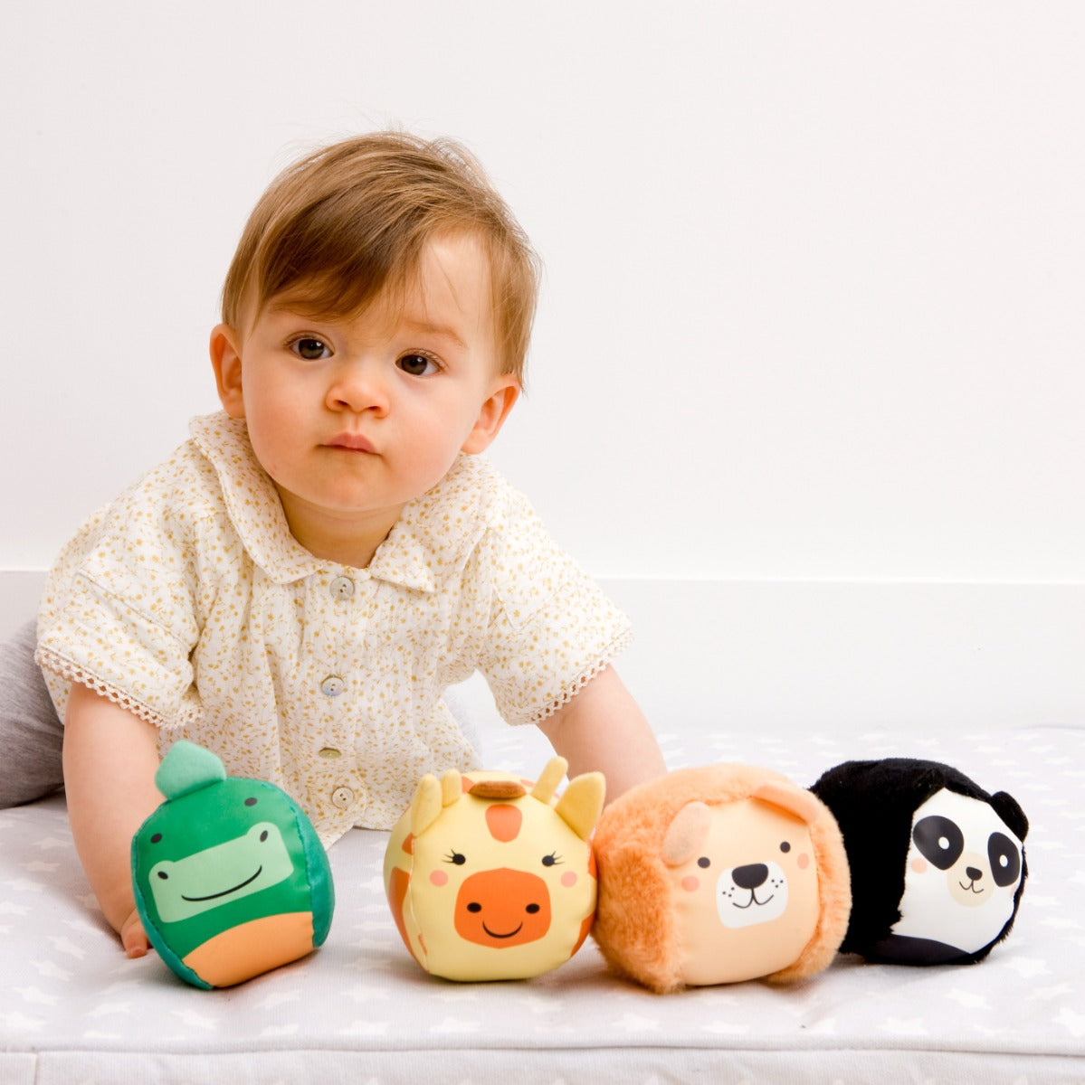 Baby girl playing with Jungle animal theme Roly Poly plush balls for kids