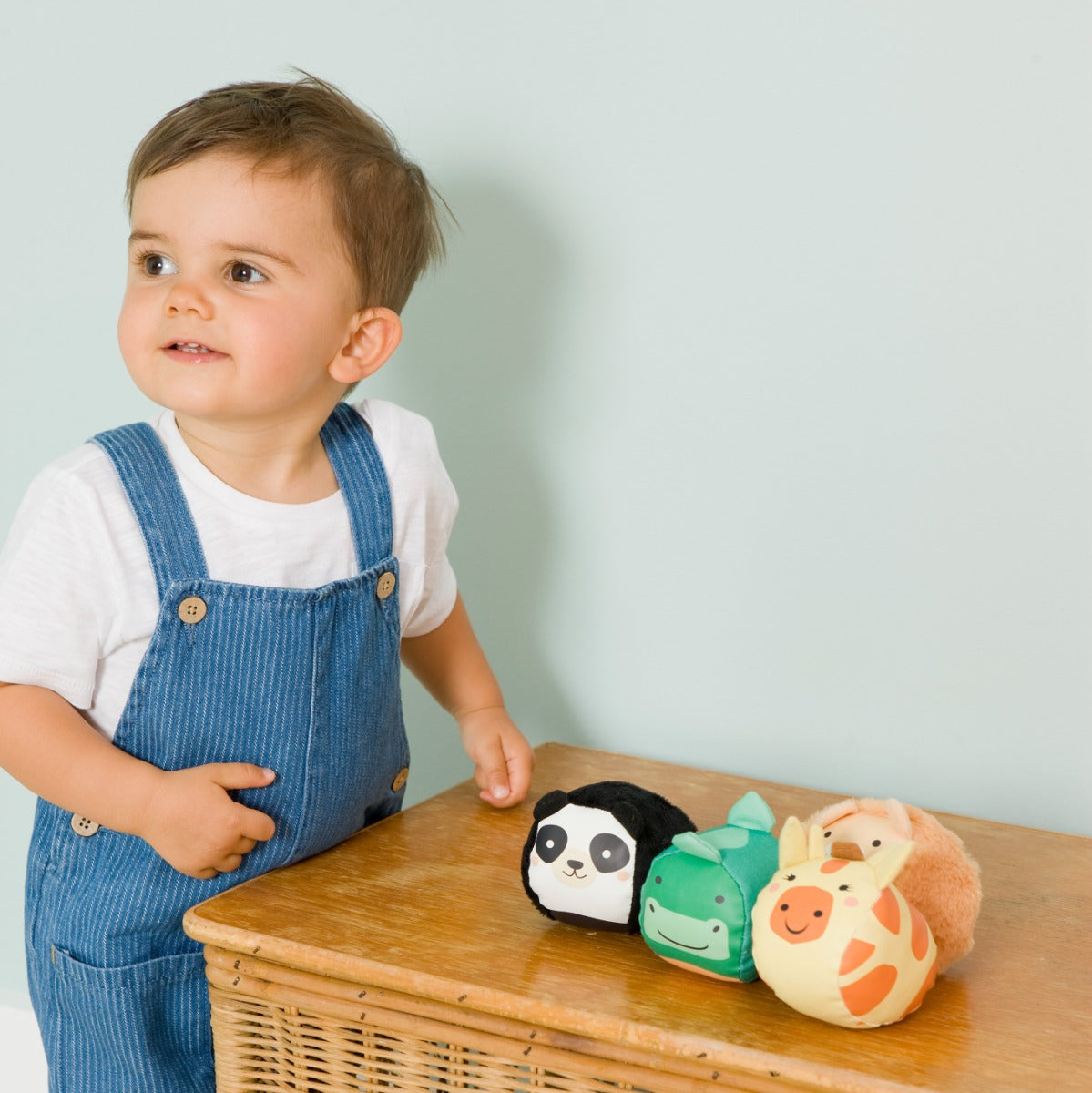Toddler playing with Jungle animal theme Roly Poly plush balls for kids