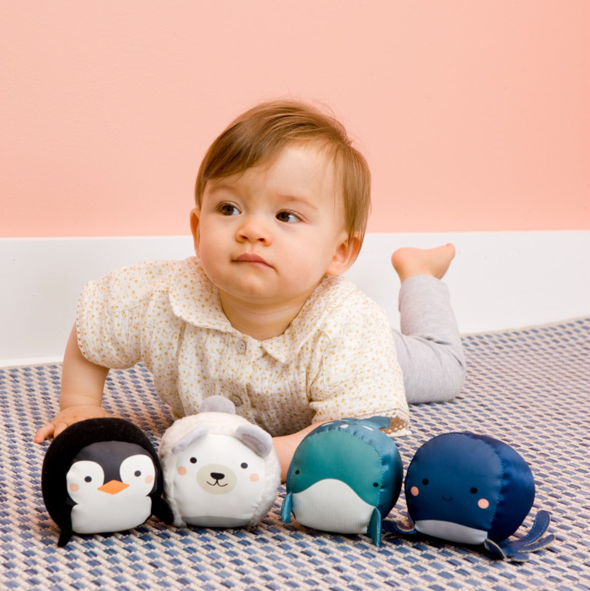 Little girl playing Aquatic animals theme Roly Poly Plush Balls on the floor
