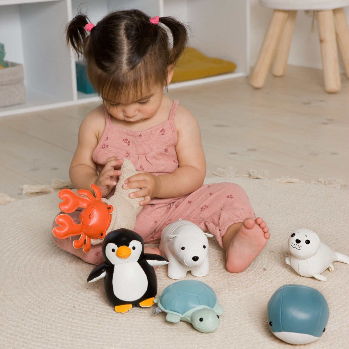 Baby girl playing with Tiny Friends - Elliot the Seal, penguin, Scorpio, turtle, fish from Little Big Friends