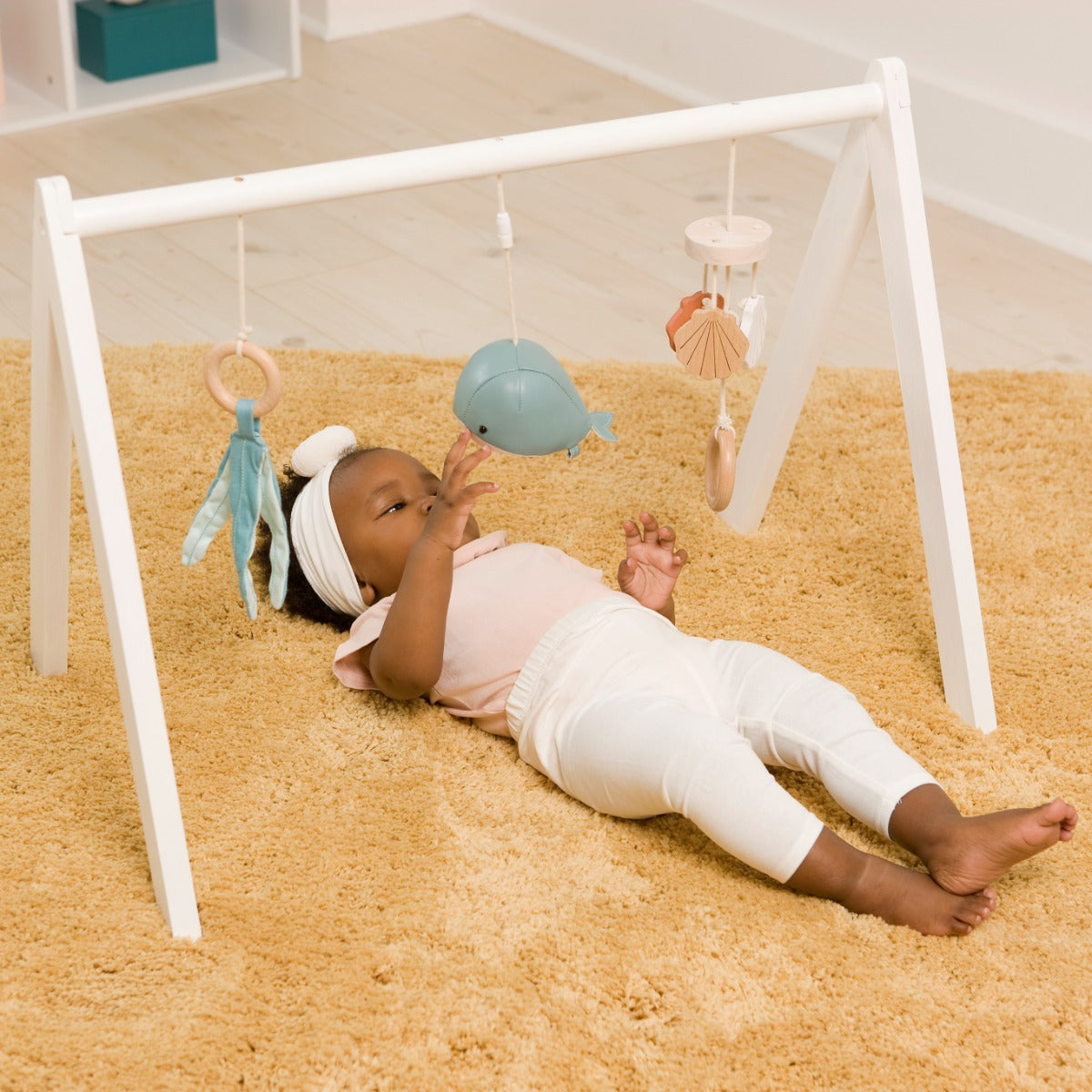 Little baby playing with Little big friends activity arch ocean on the ground 