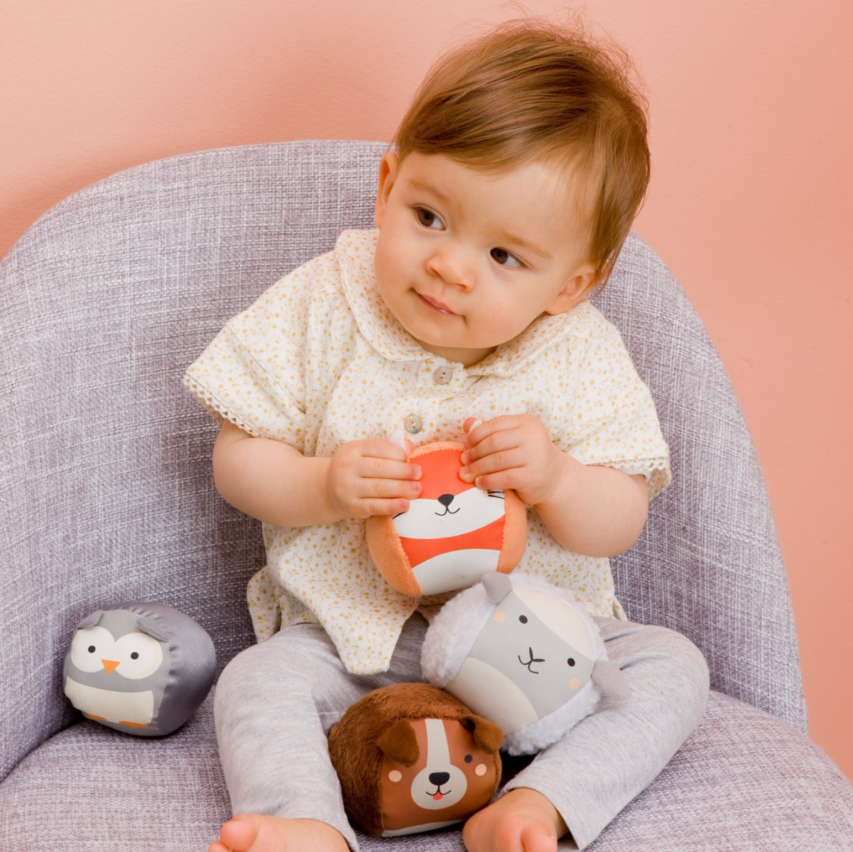 Baby girl holding Roly Poly soft animals balls for kids from Little Big Friends