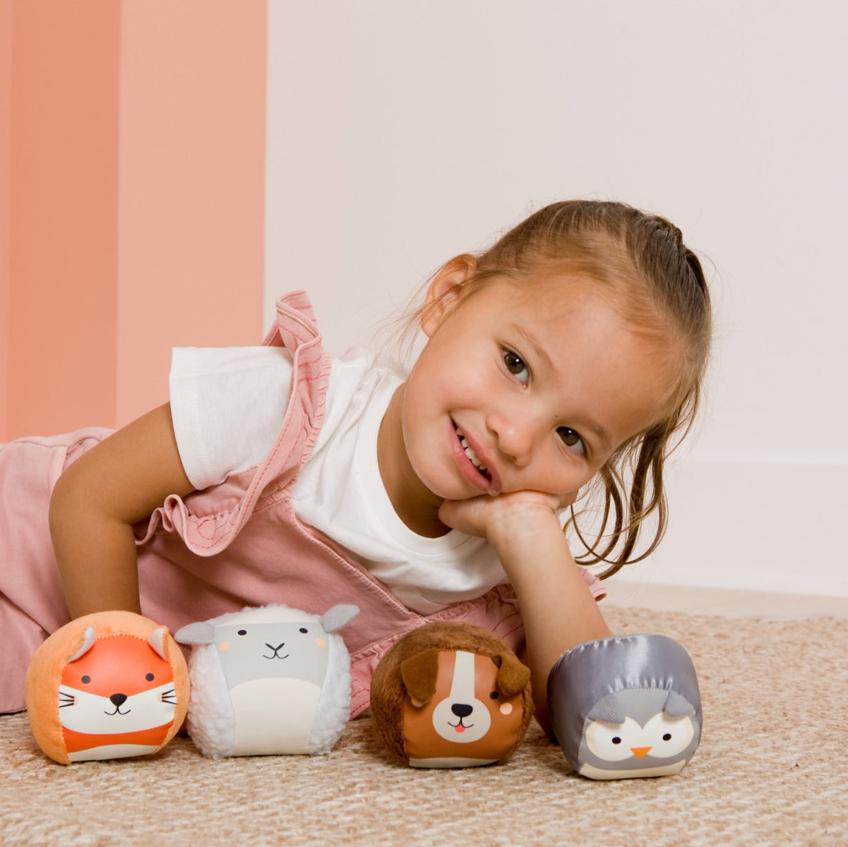 Girl posing for photo with Roly Poly soft animals balls for kids from Little Big Friends