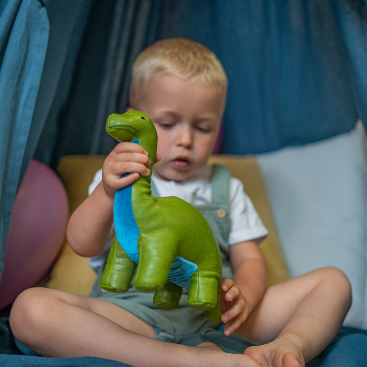 Little boy playing with Little big friends Hector the Brachiosaurus