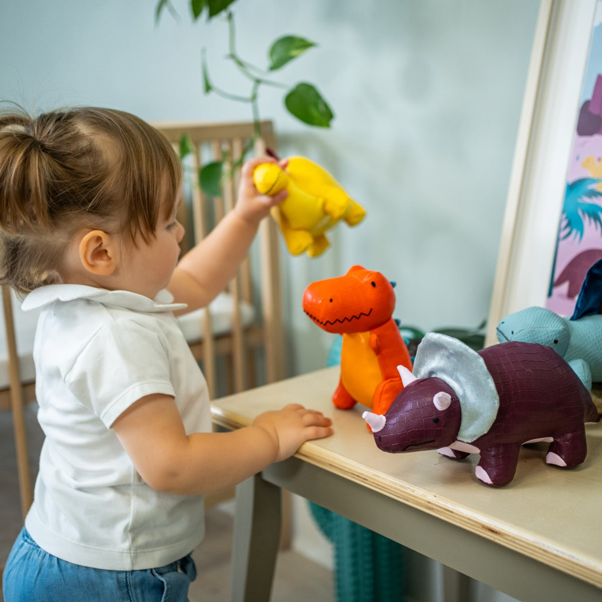 Little girl playing with Little big friends Penelope the Triceratops