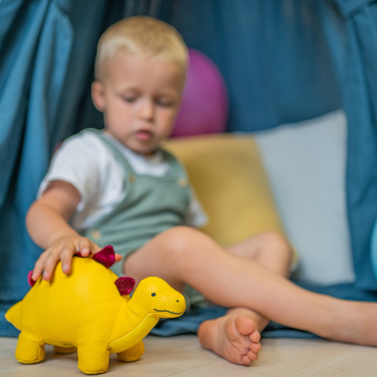 little boy playing with Little Big Friends Steffy the Stegosaurus 