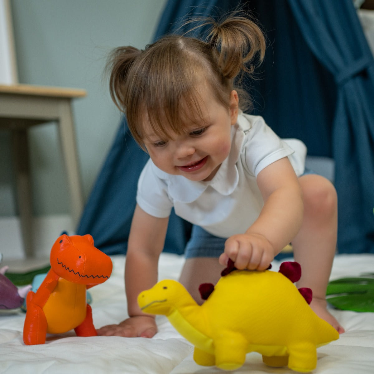 little girl playing Little Big Friends Steffy the Stegosaurus and trex