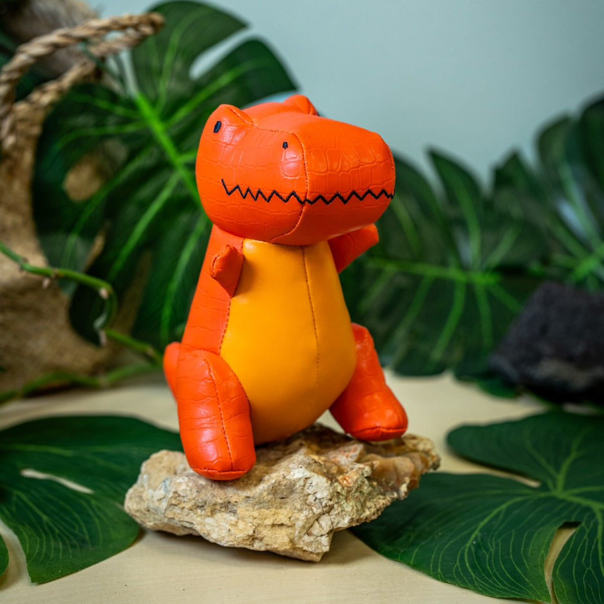 Little big friends Rex the Tyrannosaurus sitting on a rock