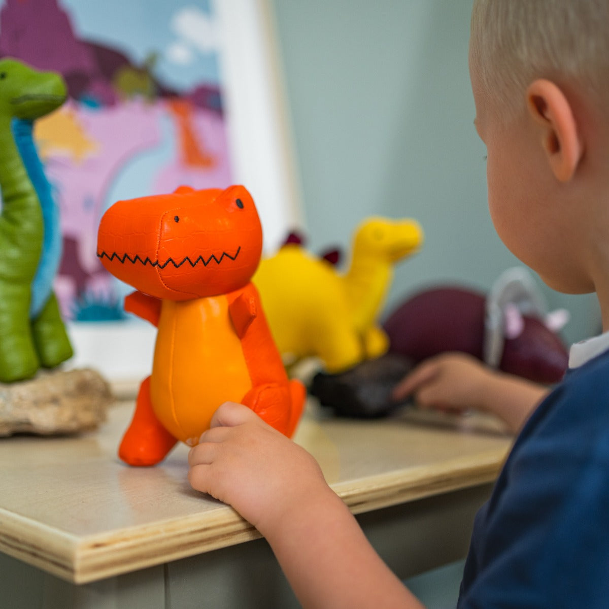 little boy playing with Little big friends Rex the Tyrannosaurus