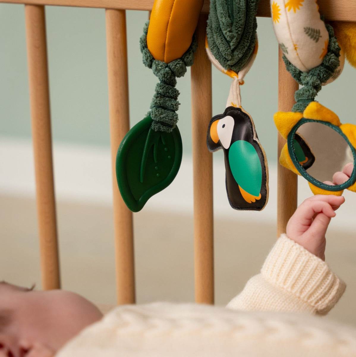 Baby playing in cot with Tiger head jungle theme activity spiral for kids from little big friends
