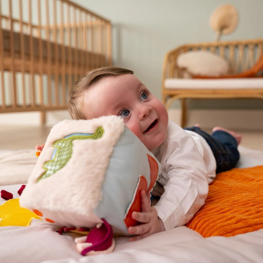Baby playing on a playmat with Little Big Friends Soft Activity Cube Dino Friends