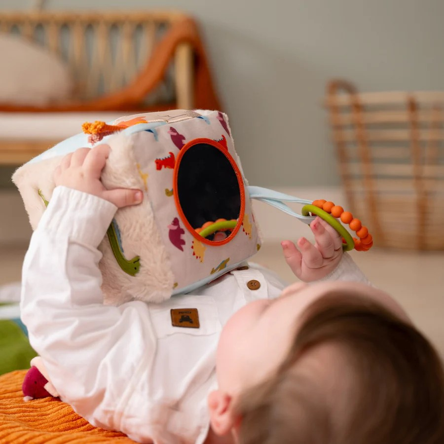 Baby playing on a playmat with Little Big Friends Soft Activity Cube Dino Friends
