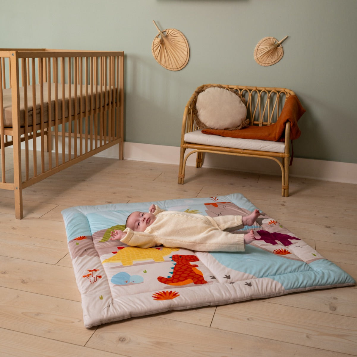 Baby sleeping on a Patchwork kids reversible playmat in Dino theme in room