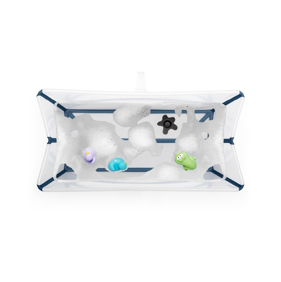 Stokke Flexi Bath in Transparent Blue with water and toys