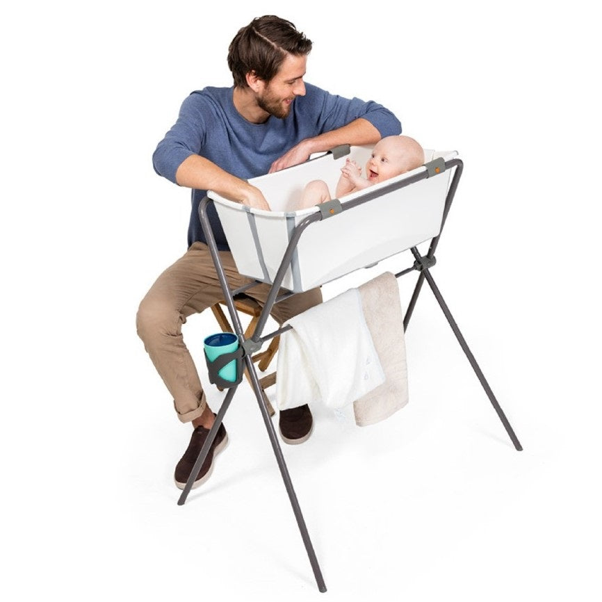 Stokke Flexi bath stand lifestyle of a dad bathing baby 