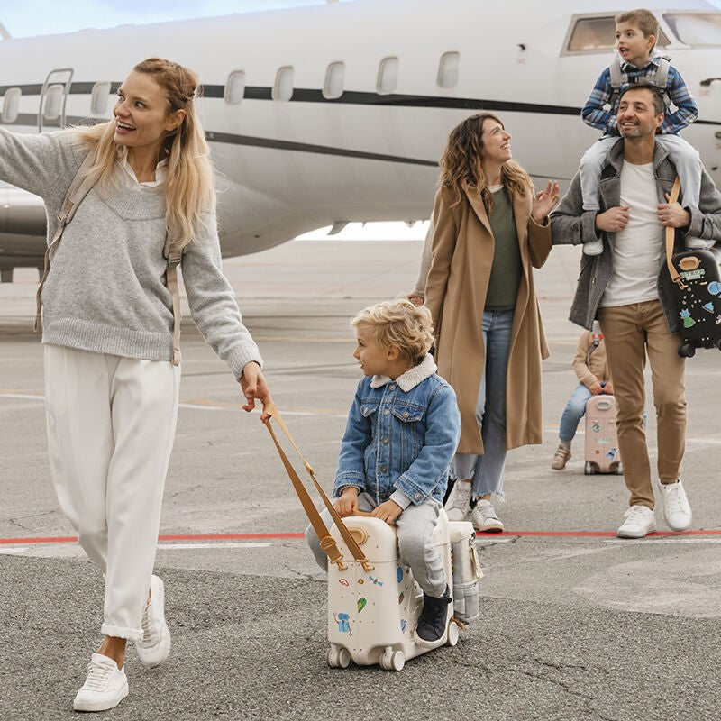 Child Sitting on Stokke Bedbox while wearing JetKids™ by Stokke® Crew Backpack in White