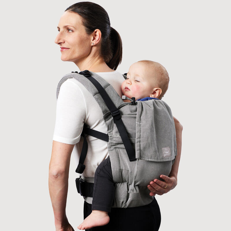 Mother carrying baby in Stokke Limas Carrier plus in Grey back carrying.