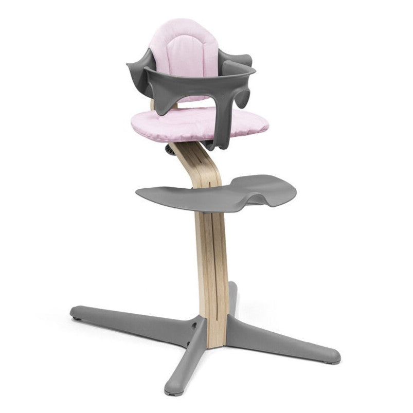 Nomi Pink cushion from Stokke attached in a chair
