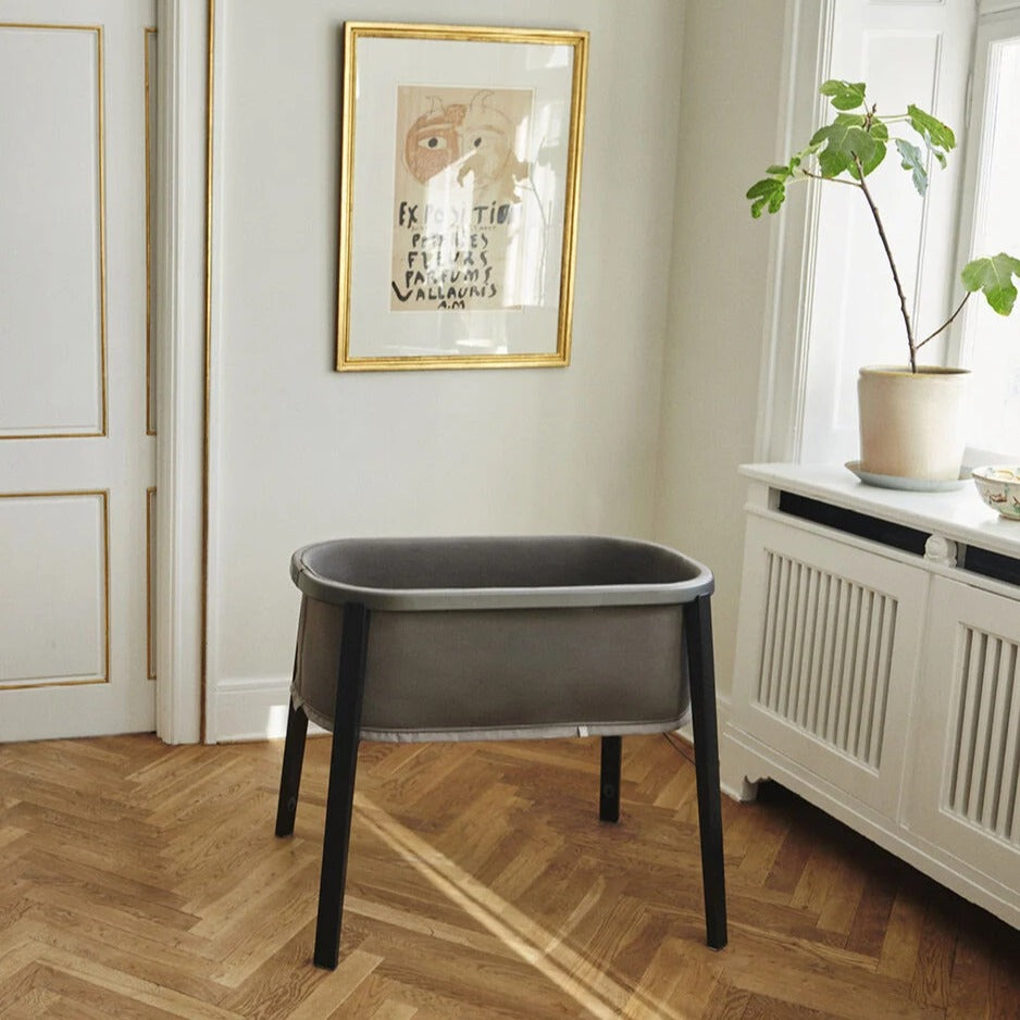 Snoozi baby portable bassinet from Stokke in a nursery room