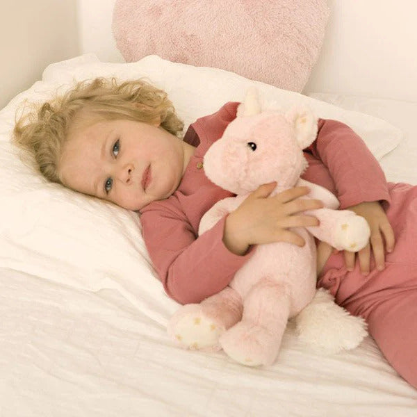 Little girl holding Cloud.b Ella the Unicorn Sleep Soother