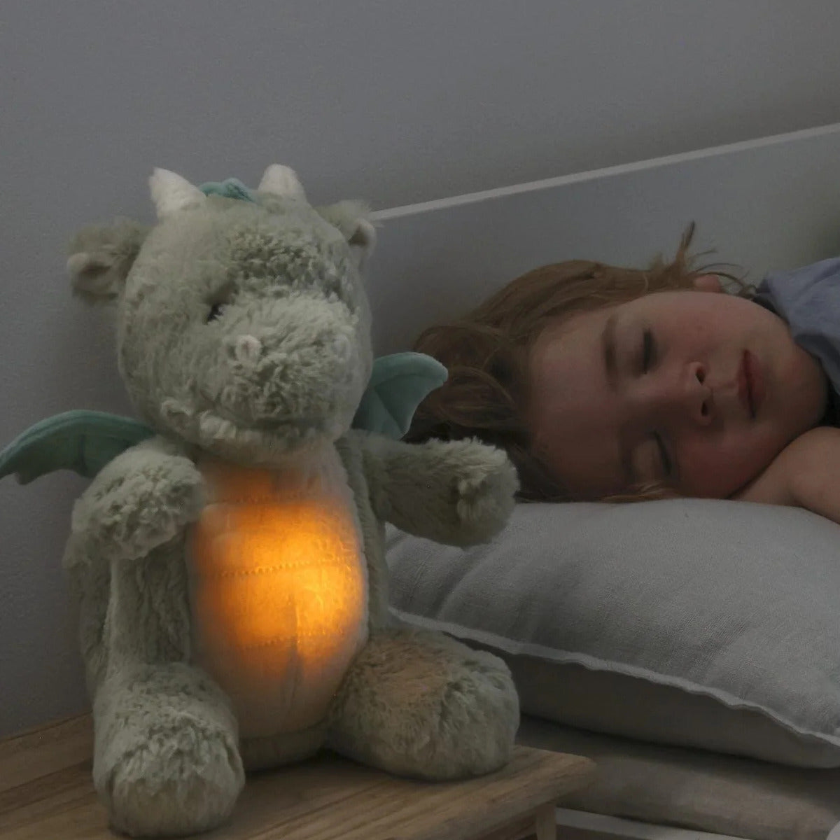 Little girl sleeping with Cloud.b Lovelight Buddies - Drake the Dragon