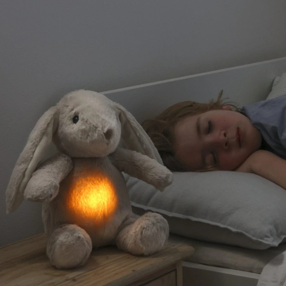 Little girl sleeping next to Cloud.b Lovelight Buddies - Billy Bunny