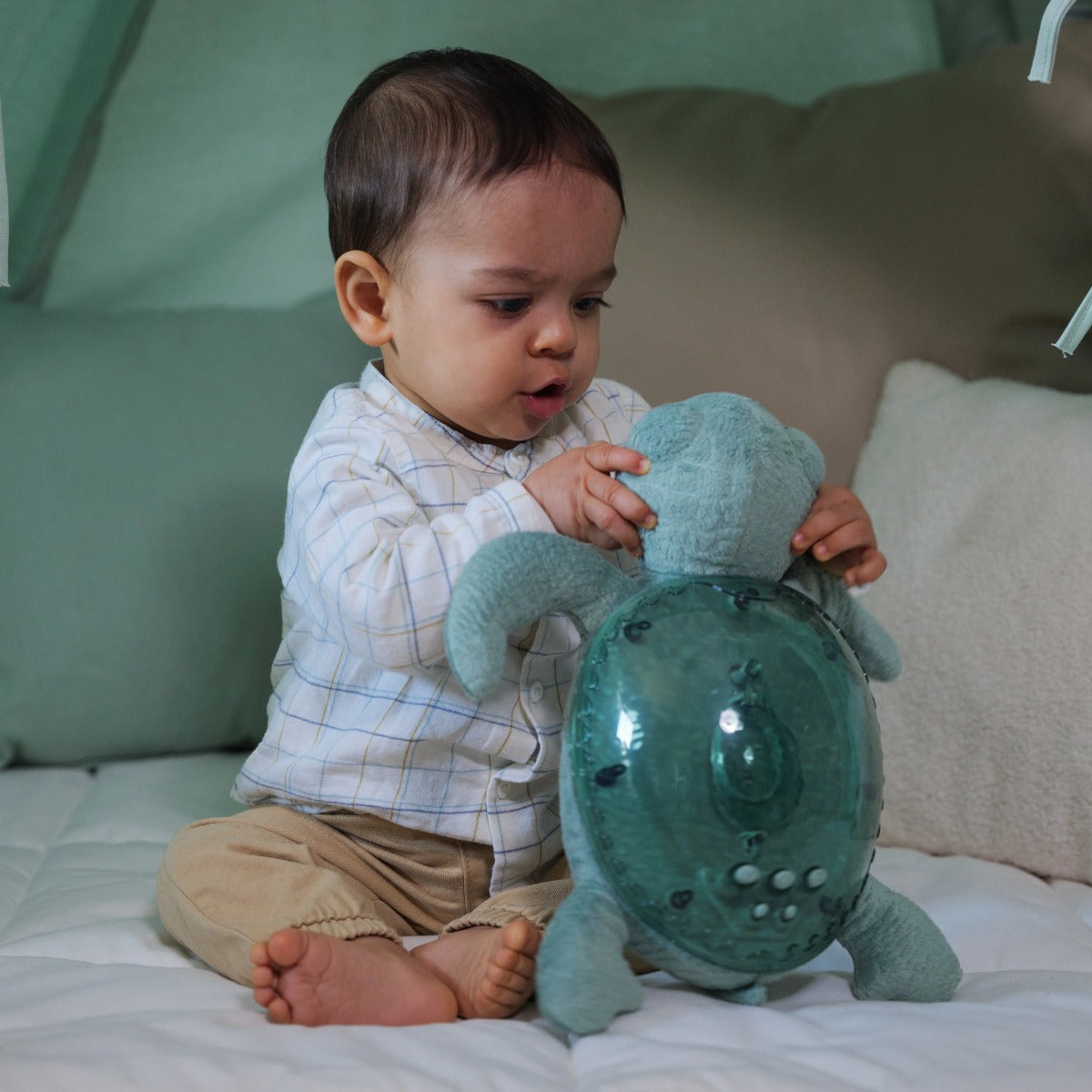 Baby playing with Cloud.b Tranquil Turtle Green