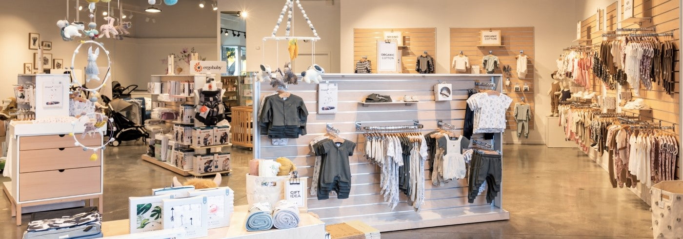 Interior of a clothing store with racks and shelves displaying various garments.