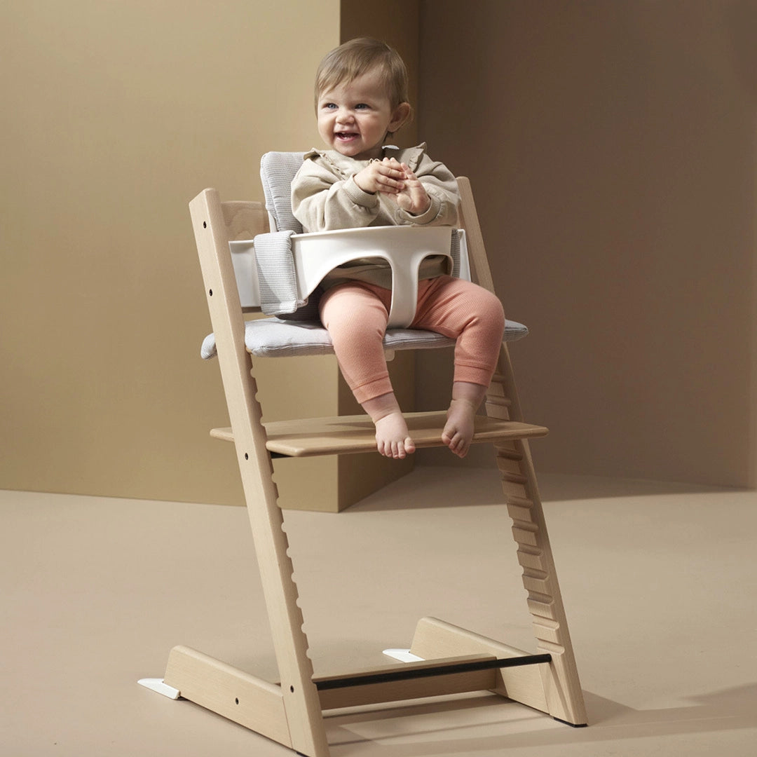 Baby sitting in Stokke tripp trapp highchair
