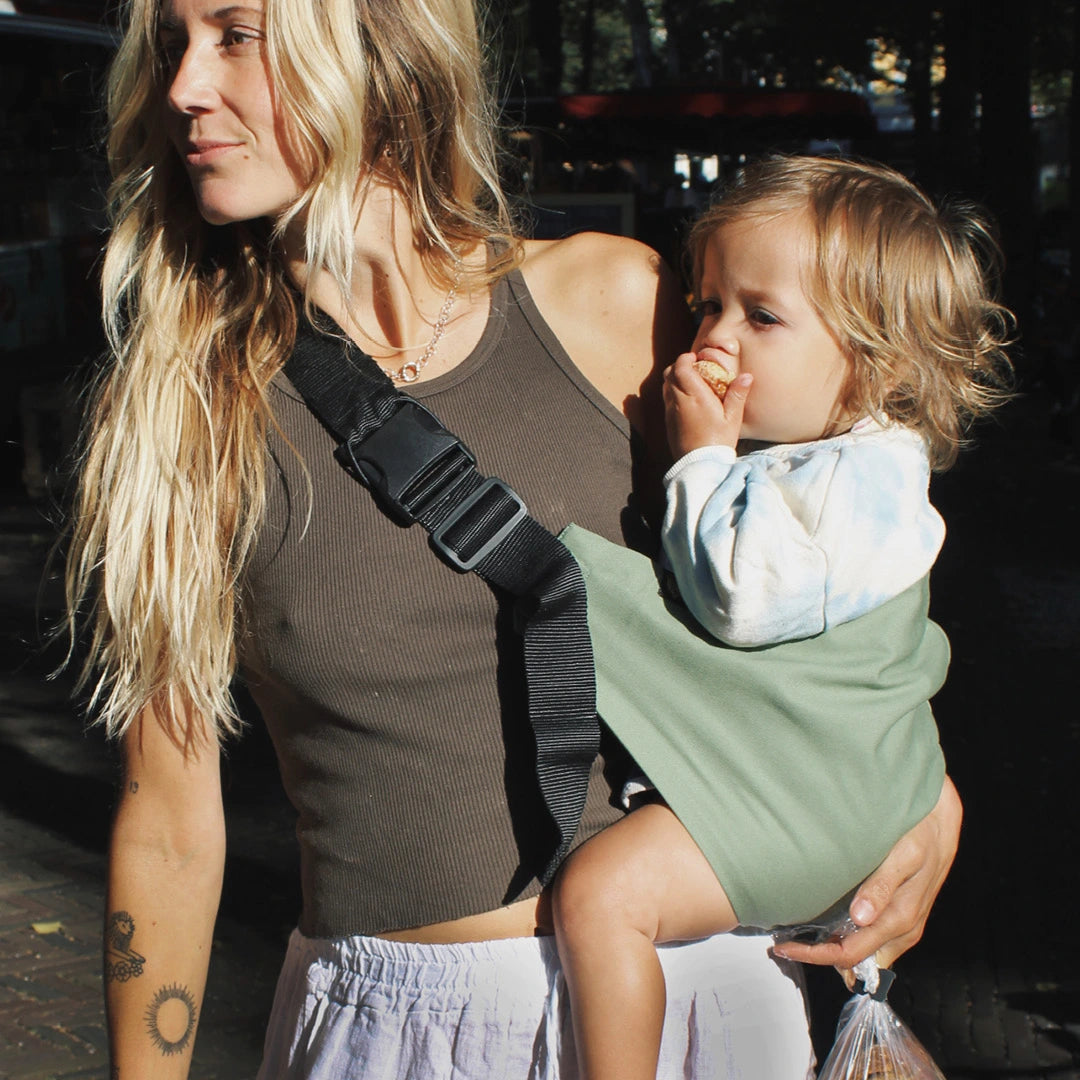 Mother holding baby in Wildride carrier