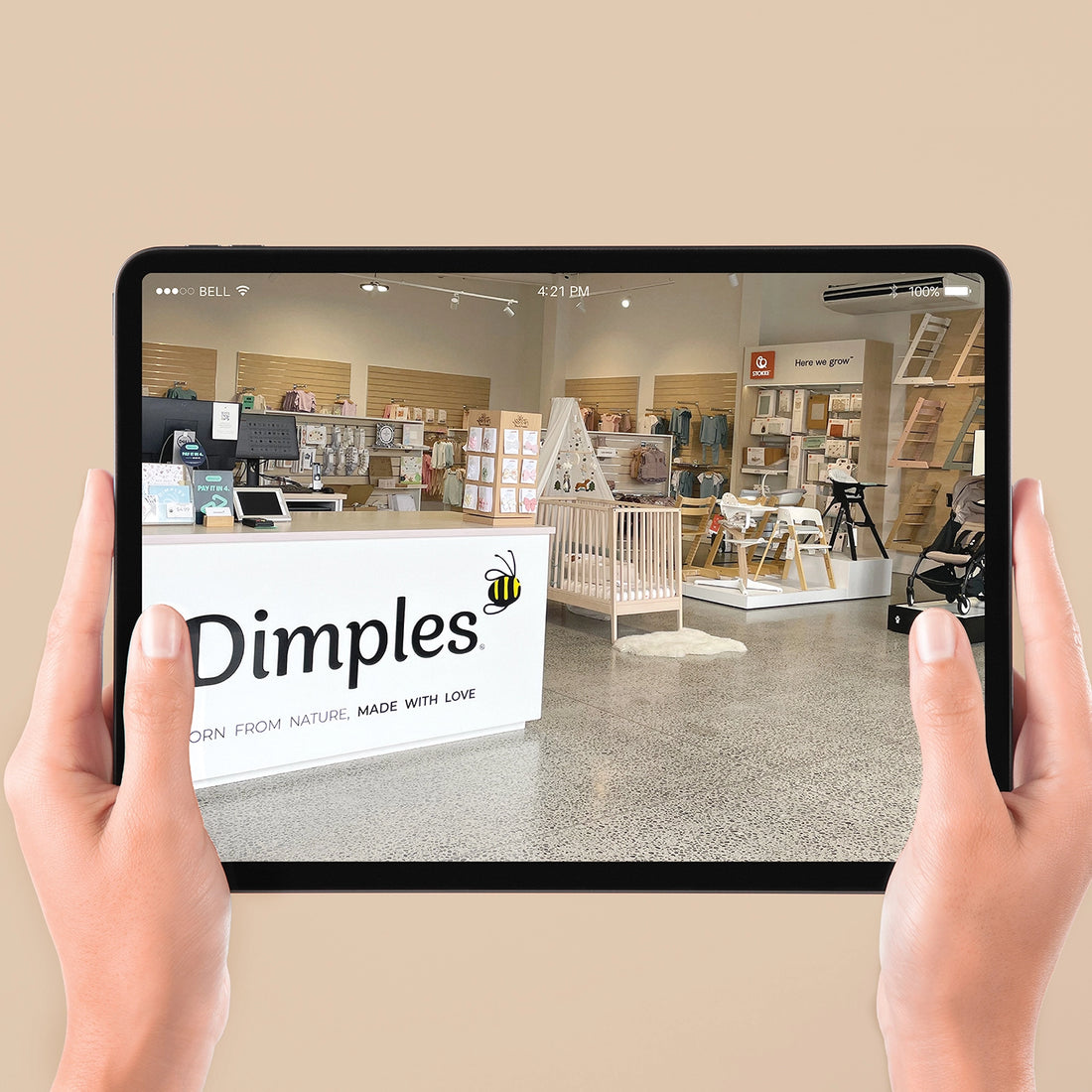 Person holding a tablet displaying an interior design store with 'Dimples' branding.