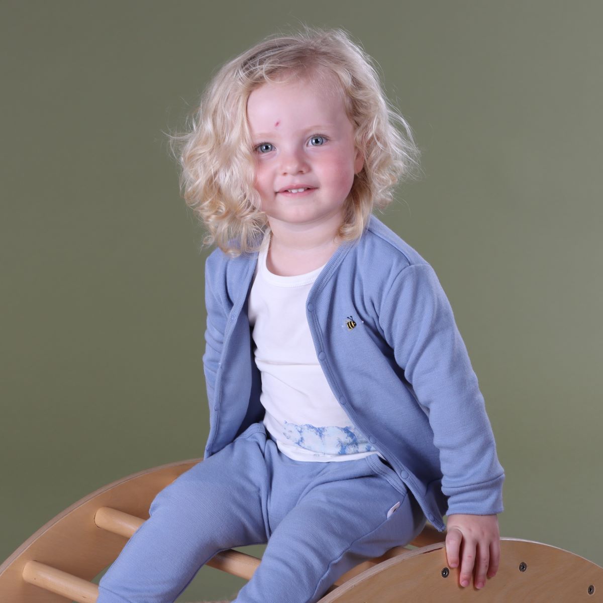 Baby wearing Merino 2 ply cardigan with buttons, merino pants and cotton top