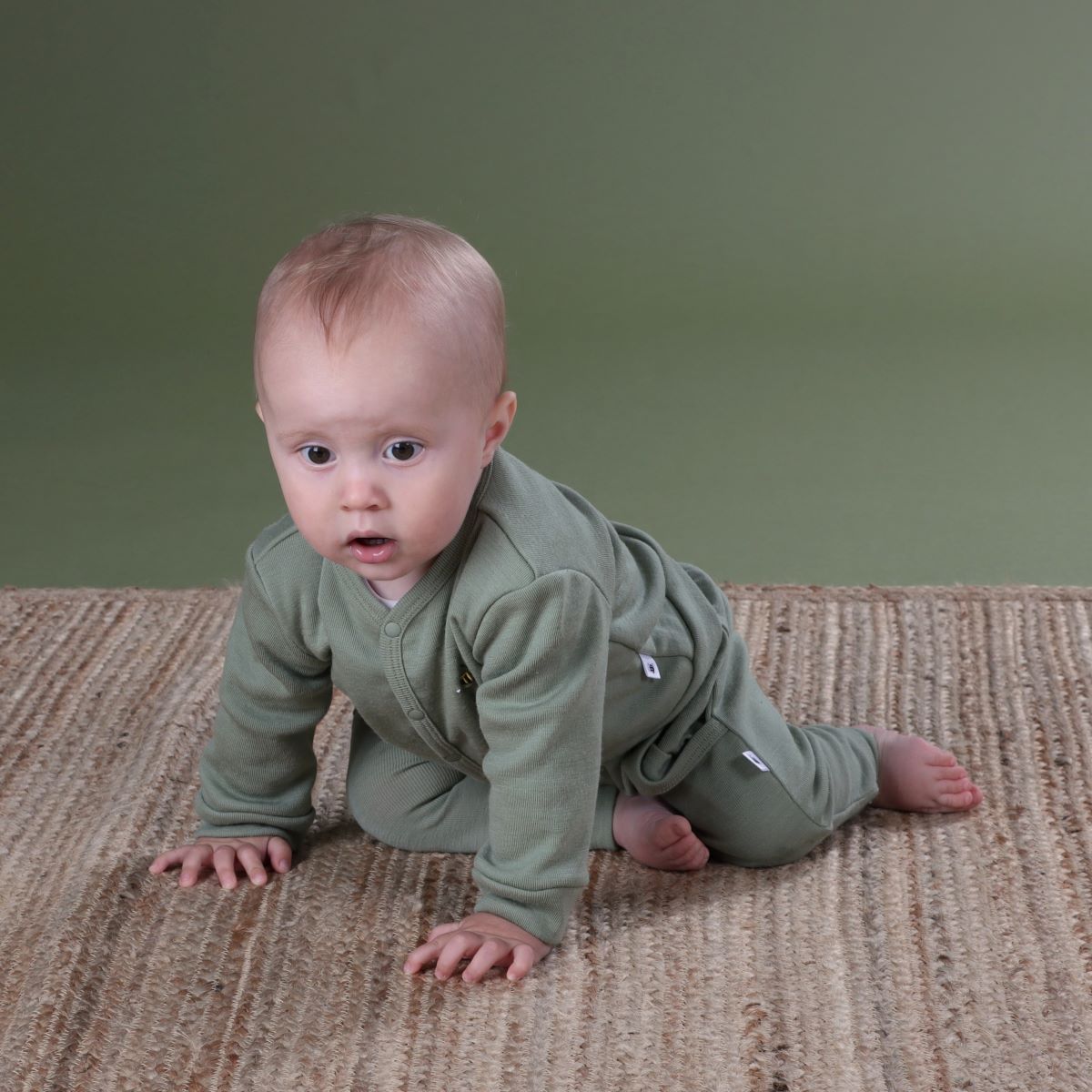 Baby wearing Merino Arctic Adventure 2ply Cardigan and Pants in Moss from Dimples
