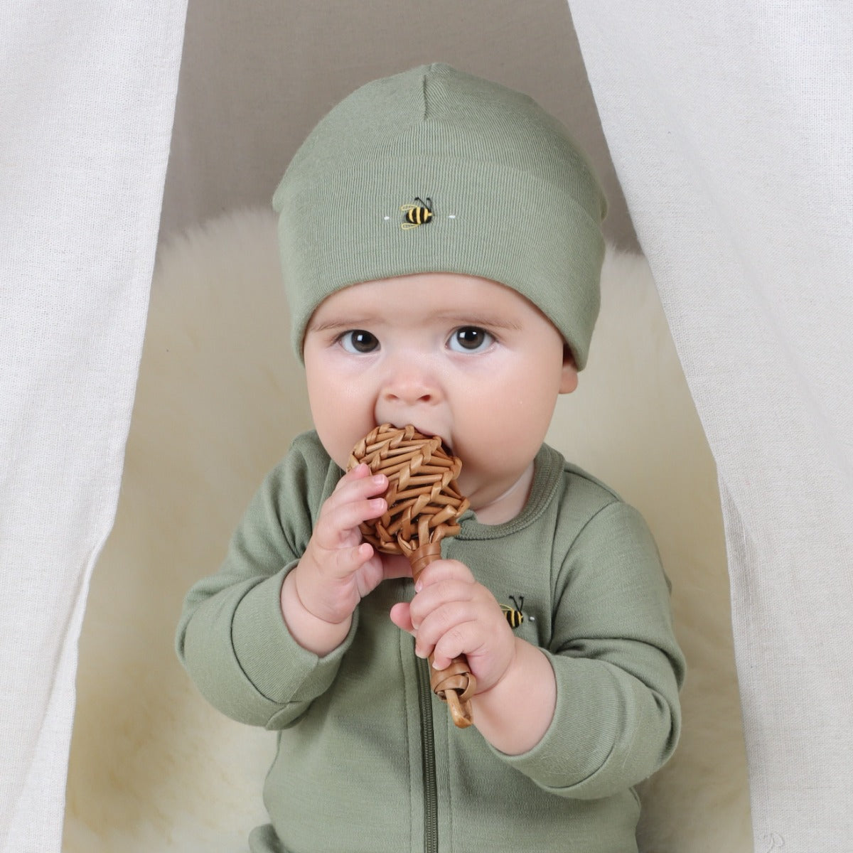 Baby wearing Merino Arctic Adventure Beanie in Moss from Dimples