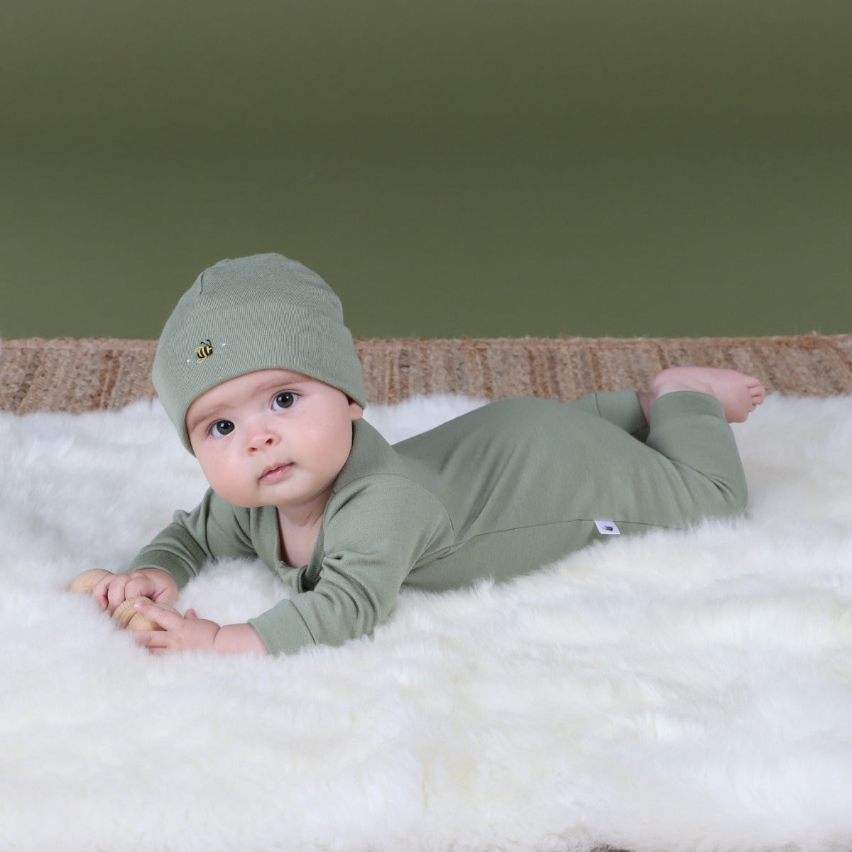 Baby wearing Merino Arctic Adventure Beanie in Moss from Dimples