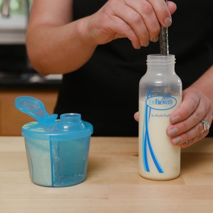 lady mixing powder in a bottle from Dr Brown's Blue Milk Powder Dispenser