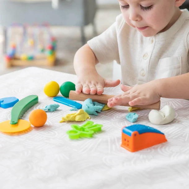 Baby boy playing playdough on Wander waterproof splat mat by bumkins.