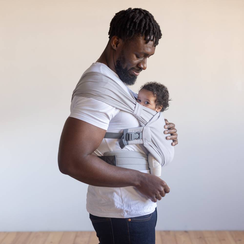 Man holding baby in Boba Bliss carrier in grey