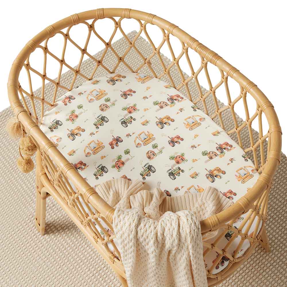 Snuggle Hunny Bassinet Sheet with Diggers and Tractors print in a bassinet