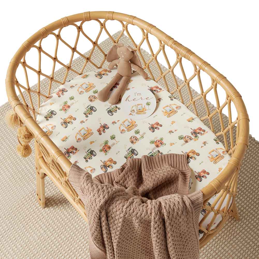 Snuggle Hunny Bassinet fitted Sheet with Diggers and Tractors print in a bassinet with knit blanket