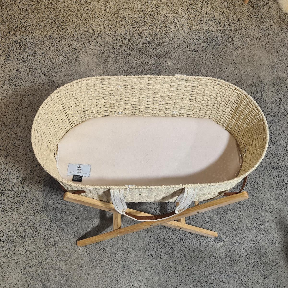 Dri-cot wool mattress protector in a Moses basket, bassinet