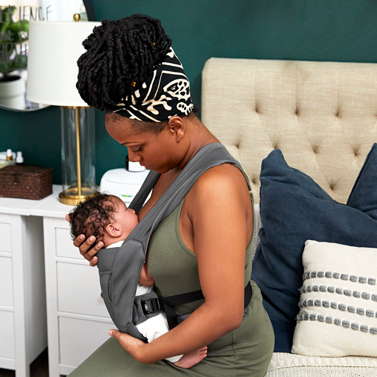Mother breastfeeding baby in Black Embrace Soft Air Mesh Carrier from Ergobaby