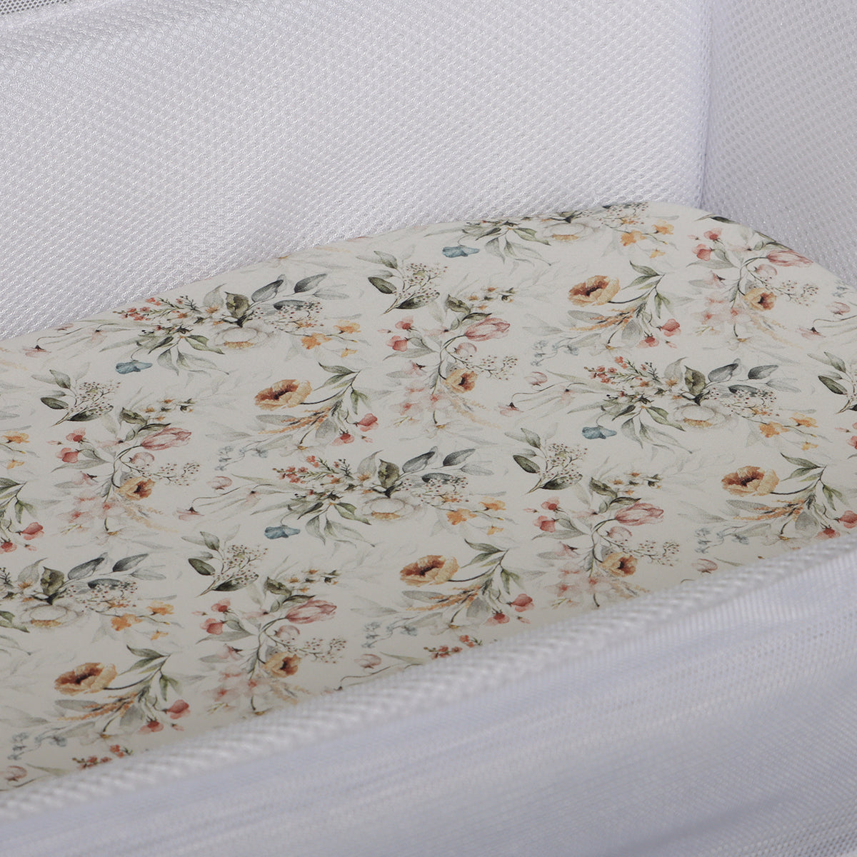 Baby bassinet sheet with vintage floral print in a bassinet