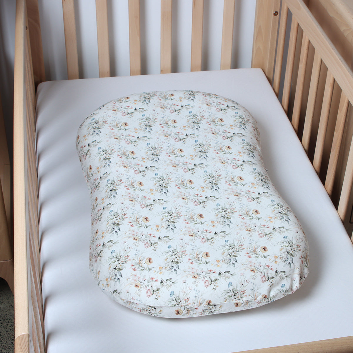 Lounger in a cot with floral lounger cover