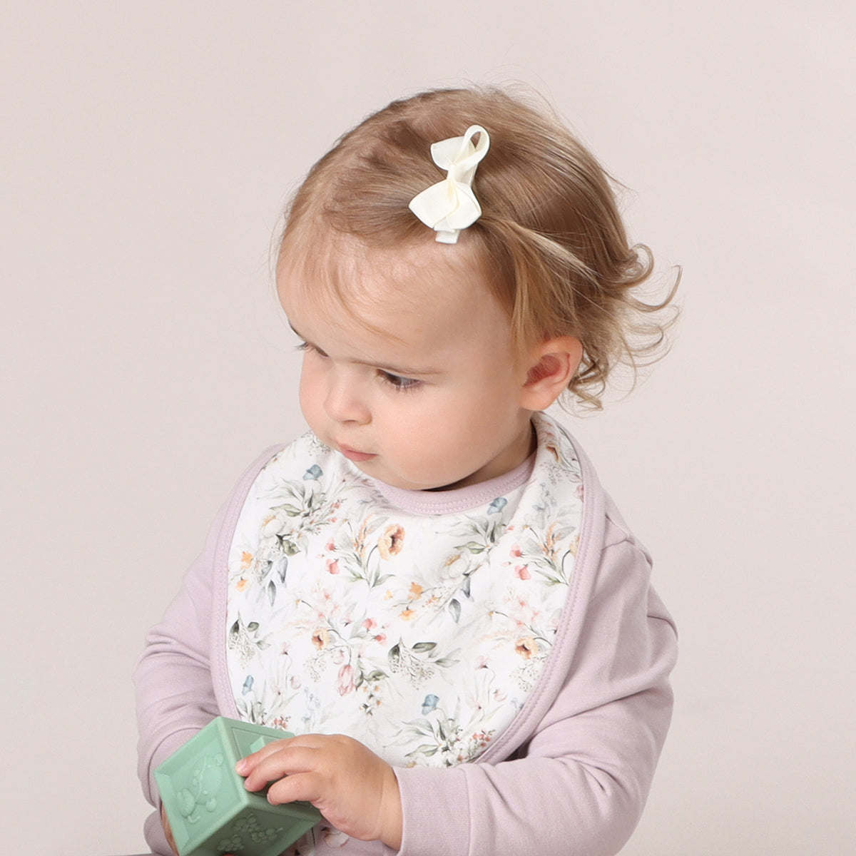 baby wearing floral bib
