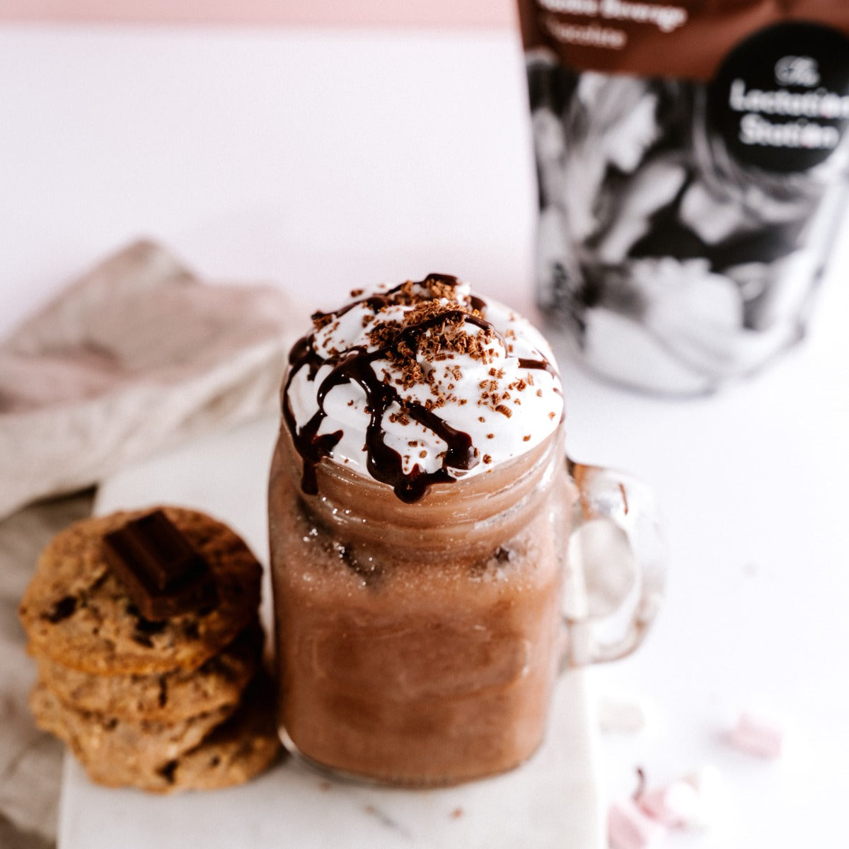 Ice chocolate made with lactation station chocolate boobie beverage mix with side of cookie
