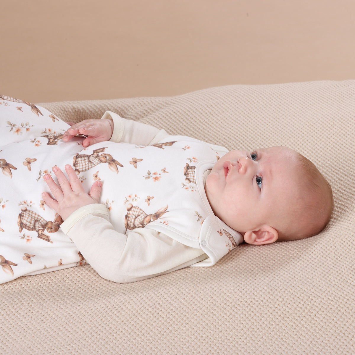 Baby boy wearing All season merino/cotton sleeping bag with bunny book print