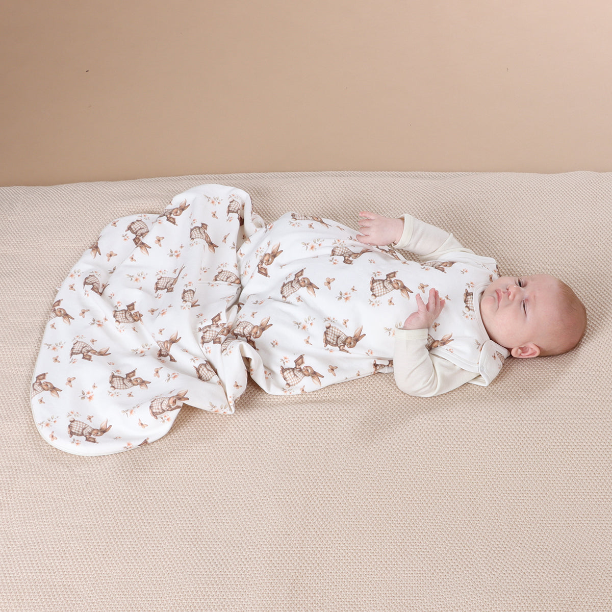 Baby boy sleeping wearing All season merino/cotton sleeping bag with bunny book print