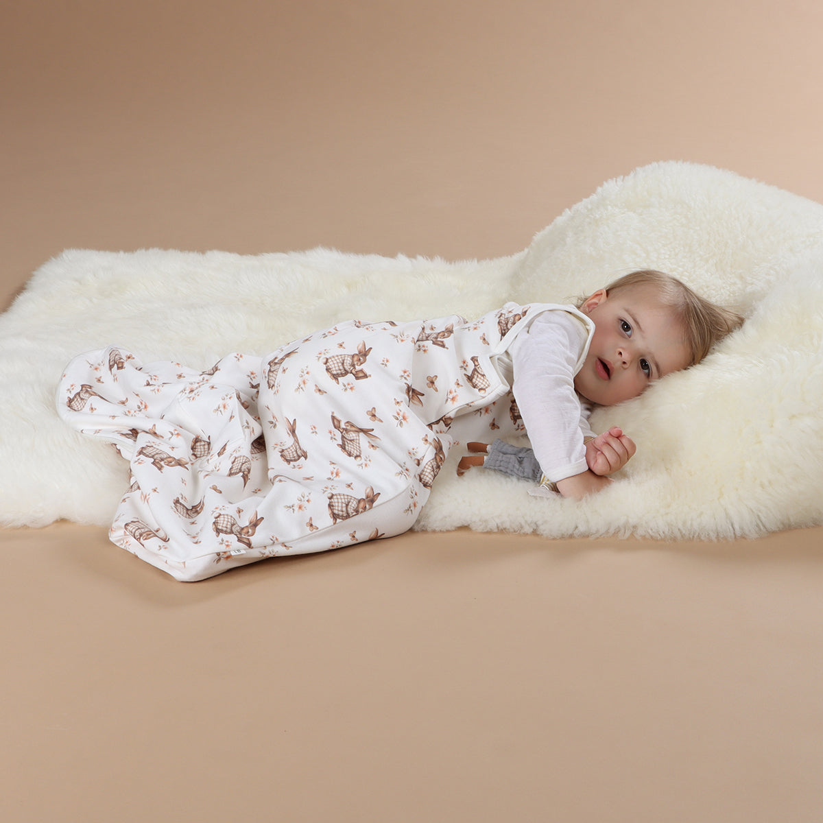 Baby girl wearing All season merino/cotton sleeping bag with bunny book print