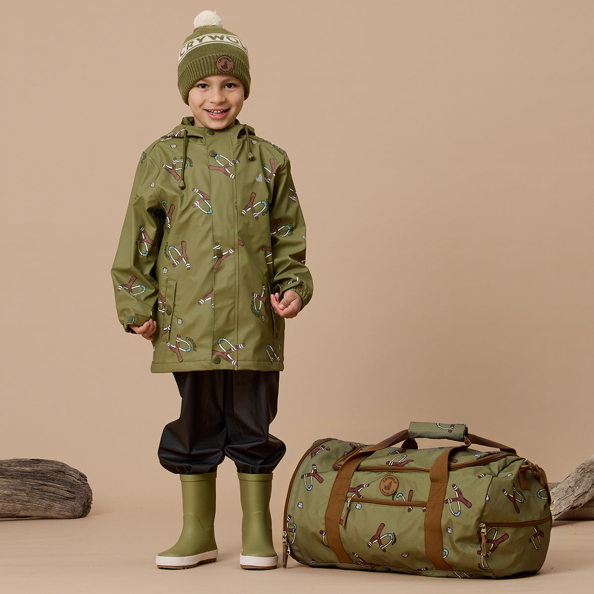 Toddler boy holding Catapult print recycled duffel bag